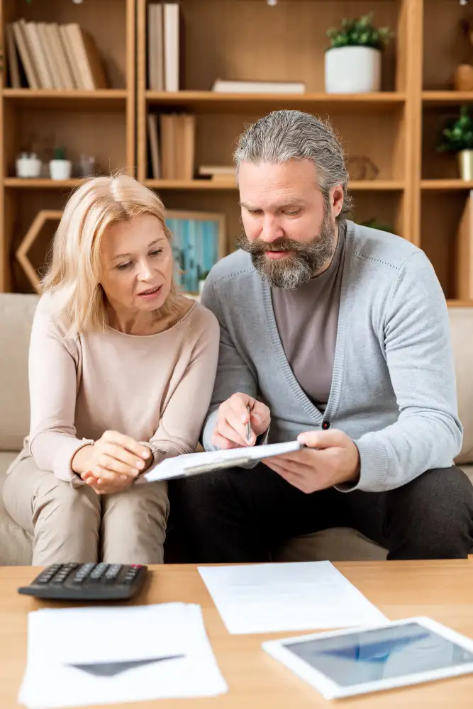 Couple reviewing account receivable management financial documents at home at Predawn Accounting