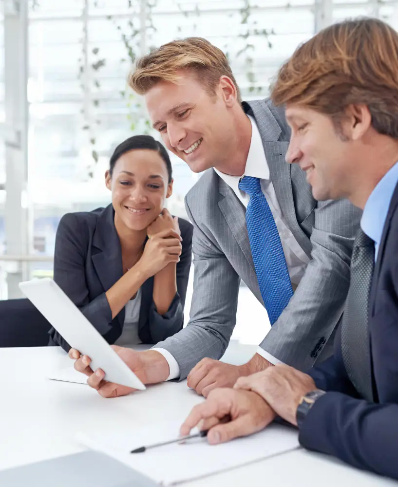 Professionals discussing financial advisory services on a tablet