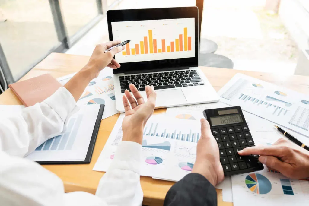 Financial experts analyzing business data reports and bar charts during a chart of account setup