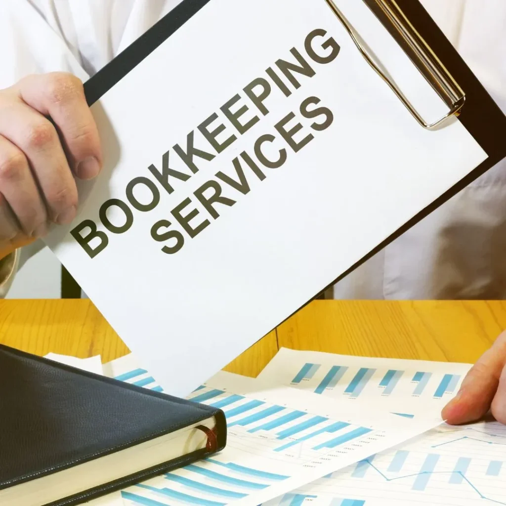 Bookkeeping document with financial charts and records on a desk.