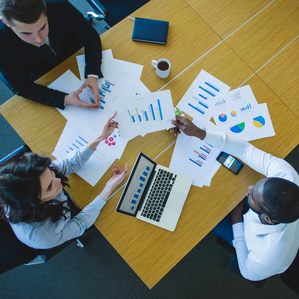 Team analyzing reports and charts with Power BI consulting services