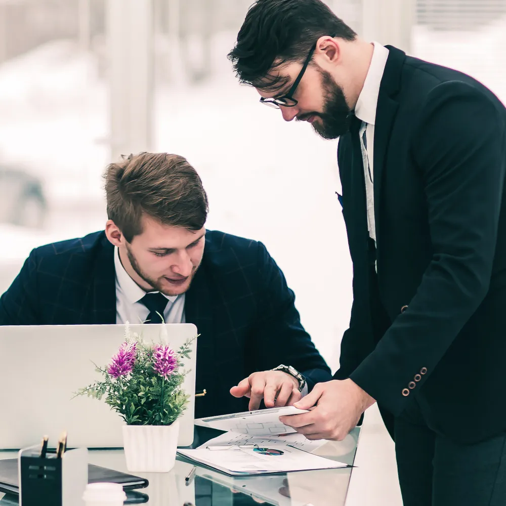 Two business professionals analyzing financial documents for bookkeeping services